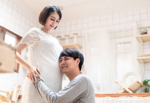 asian-man-father-holding-pregnancy-mother-tummy-li-2021-10-29-02-08-20-utc