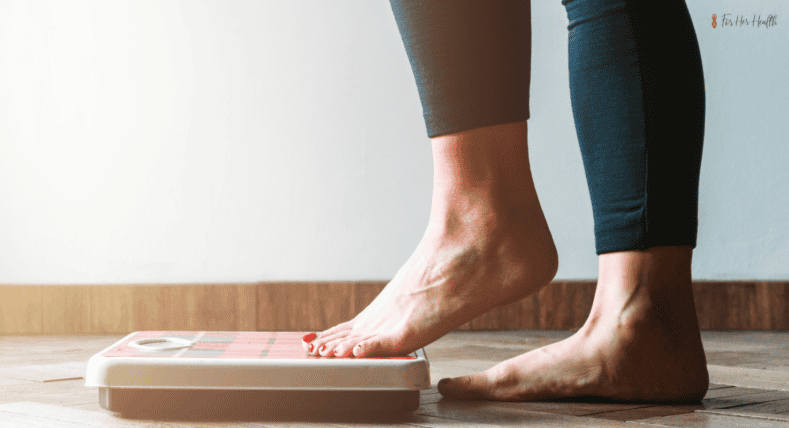 woman stepping on the scale