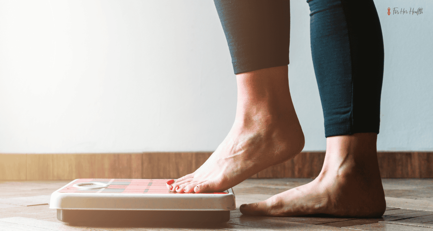 woman stepping on the scale